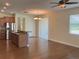 Open kitchen with stainless steel appliances, a breakfast bar, and wood flooring at 20101 Oakflower Ave, Tampa, FL 33647