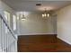 Spacious living room with hardwood floors, large windows and an elegant chandelier at 20101 Oakflower Ave, Tampa, FL 33647