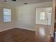 Bright living room features wood floors, light-colored walls, and a window with blinds at 20101 Oakflower Ave, Tampa, FL 33647