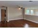 Spacious living room with hardwood floors and a ceiling fan for added comfort at 20101 Oakflower Ave, Tampa, FL 33647