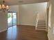 Open-concept living room with hardwood floors and sliding glass doors to the yard at 20101 Oakflower Ave, Tampa, FL 33647