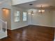 Open floor plan living room features hardwood floors, natural light and a chandelier at 20101 Oakflower Ave, Tampa, FL 33647