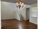 Bright living room features hardwood floors, staircase, and an elegant chandelier at 20101 Oakflower Ave, Tampa, FL 33647