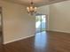Spacious living room boasts hardwood floors, natural light, and sliding glass door at 20101 Oakflower Ave, Tampa, FL 33647