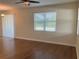 Living room features wood floors, neutral walls, ceiling fan, and a window with blinds at 20101 Oakflower Ave, Tampa, FL 33647