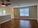 An open loft is illuminated with natural light through the window and features hardwood floors at 20101 Oakflower Ave, Tampa, FL 33647