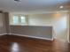 Hardwood floors accent this loft space with neutral colored walls and recessed lighting at 20101 Oakflower Ave, Tampa, FL 33647