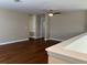 Open concept loft with hardwood floors, neutral colored walls, and a ceiling fan at 20101 Oakflower Ave, Tampa, FL 33647