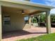 Covered patio featuring brick pavers, ceiling fan, and views of the backyard at 20101 Oakflower Ave, Tampa, FL 33647