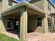 Covered patio featuring brick pavers, ceiling fan, and views of the backyard at 20101 Oakflower Ave, Tampa, FL 33647