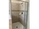 Walk-in shower with glass door and tiled walls providing a spa-like experience at 20101 Oakflower Ave, Tampa, FL 33647