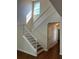 Bright staircase features white banister and an overhead transom window at 20101 Oakflower Ave, Tampa, FL 33647