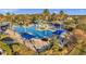 Aerial view of a beautiful community pool with palm trees and plenty of seating at 22359 Storybook Cabin Way, Land O Lakes, FL 34637