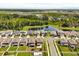 Scenic aerial view showcases backyard spaces, neighborhood layout, and nearby natural pond at 22359 Storybook Cabin Way, Land O Lakes, FL 34637