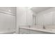 Bathroom featuring double sink vanity with shower and tile walls at 22359 Storybook Cabin Way, Land O Lakes, FL 34637