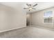 Neutral bedroom featuring carpet, ceiling fan, and a window at 22359 Storybook Cabin Way, Land O Lakes, FL 34637