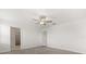 Bright bedroom featuring carpet, ceiling fan, and doors to closet and hallway at 22359 Storybook Cabin Way, Land O Lakes, FL 34637