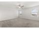 Bright bedroom with carpet, two windows, and a ceiling fan at 22359 Storybook Cabin Way, Land O Lakes, FL 34637