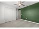 Neutral carpet in a bright bedroom with ceiling fan and closet at 22359 Storybook Cabin Way, Land O Lakes, FL 34637
