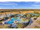Aerial view of the amazing community pool surrounded by lush landscaping at 22359 Storybook Cabin Way, Land O Lakes, FL 34637