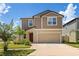 Charming two-story home features a neutral color scheme, well-maintained landscaping, and an attached two-car garage at 22359 Storybook Cabin Way, Land O Lakes, FL 34637