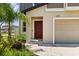 The property features a brick walkway, a red front door, and manicured landscaping at 22359 Storybook Cabin Way, Land O Lakes, FL 34637