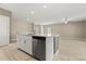 Open-concept kitchen island and Gathering room with modern appliances, stainless steel dishwasher, and tile flooring at 22359 Storybook Cabin Way, Land O Lakes, FL 34637