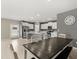 Modern kitchen featuring stainless steel appliances, white cabinets, a kitchen island, and tile flooring at 22359 Storybook Cabin Way, Land O Lakes, FL 34637