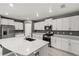 Modern kitchen featuring stainless steel appliances, white cabinets, a kitchen island, and tile flooring at 22359 Storybook Cabin Way, Land O Lakes, FL 34637