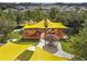 Aerial view of neighborhood playground area with slides and shade canopies at 22359 Storybook Cabin Way, Land O Lakes, FL 34637