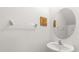 Cozy powder room with pedestal sink and mirror at 22359 Storybook Cabin Way, Land O Lakes, FL 34637