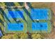 Aerial view of well-maintained blue tennis and basketball courts at 22359 Storybook Cabin Way, Land O Lakes, FL 34637