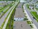 Aerial view of the townhomes in the community, showcasing the street and serene pond nearby at 2699 Suncoast Blend Dr, Odessa, FL 33556