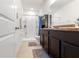 Clean bathroom features a shower, tile floor, a sink, and dark wood cabinets at 2699 Suncoast Blend Dr, Odessa, FL 33556