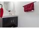Well-lit half-bathroom featuring a modern vanity with storage, mirror, and neutral tones at 2699 Suncoast Blend Dr, Odessa, FL 33556