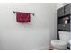 Well-appointed half-bathroom with a toilet, towel rack, cabinet, and decorative elements at 2699 Suncoast Blend Dr, Odessa, FL 33556