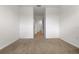 Empty bedroom with neutral walls, carpet flooring, and a view of an adjacent hallway at 2699 Suncoast Blend Dr, Odessa, FL 33556