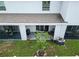 View of covered patio with grill, outdoor furniture, and a small tree, creating a relaxing outdoor space at 2699 Suncoast Blend Dr, Odessa, FL 33556