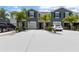 Charming townhomes with well-maintained lawns, palm trees, and ample parking spaces for residents and visitors at 2699 Suncoast Blend Dr, Odessa, FL 33556