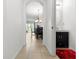 Bright hallway with tiled floors leads to a dining area and powder room with a modern vanity at 2699 Suncoast Blend Dr, Odessa, FL 33556