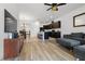 Open-concept living space with hardwood floors, a modern kitchen, and comfortable seating perfect for entertaining at 2699 Suncoast Blend Dr, Odessa, FL 33556