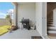 Outdoor patio with grilling area, potted plants, and stairs that lead to the second story at 2699 Suncoast Blend Dr, Odessa, FL 33556