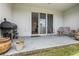 Relaxing patio features a grill, outdoor seating, and sliding glass doors to the home's interior at 2699 Suncoast Blend Dr, Odessa, FL 33556