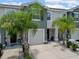 Two-story townhomes showcasing driveway, landscaping, and modern architectural details at 2699 Suncoast Blend Dr, Odessa, FL 33556