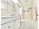 Bright bathroom featuring a tub, shower, white vanity, and updated fixtures at 2707 56Th S St, Gulfport, FL 33707
