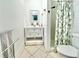 Clean bathroom featuring a white vanity, white tile flooring and walls, and a shower at 2707 56Th S St, Gulfport, FL 33707