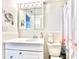 Bright bathroom featuring a mirrored vanity, white fixtures, and a floral shower curtain at 2707 56Th S St, Gulfport, FL 33707