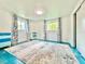 Spacious bedroom with two windows, neutral walls, and a light-colored area rug at 2707 56Th S St, Gulfport, FL 33707