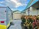 Exterior view of the property featuring a vintage camper, garage, and lush landscaping along the side of the house at 2707 56Th S St, Gulfport, FL 33707
