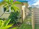 Side of the house featuring landscaping, an air conditioner, and a wooden fence at 2707 56Th S St, Gulfport, FL 33707